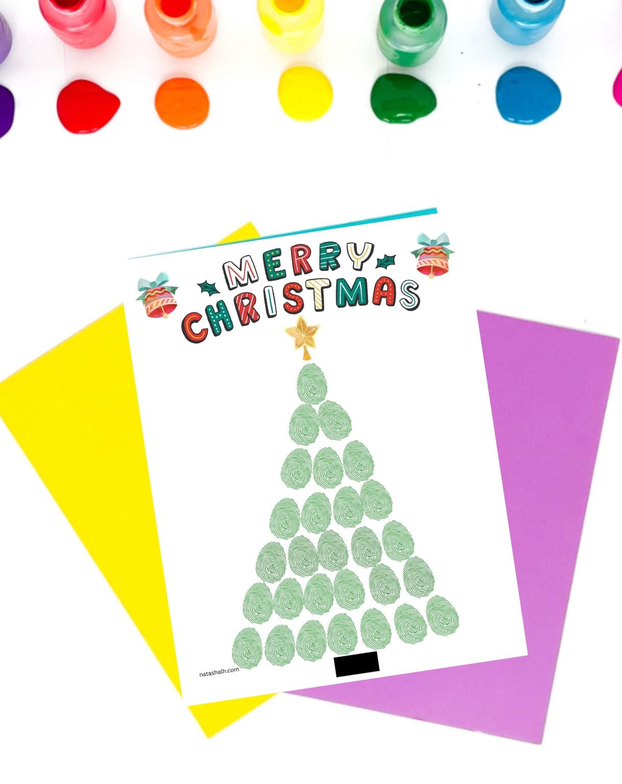 a completed fingerprint craft showing a Christmas tree on a surface with open bottles of poster paint