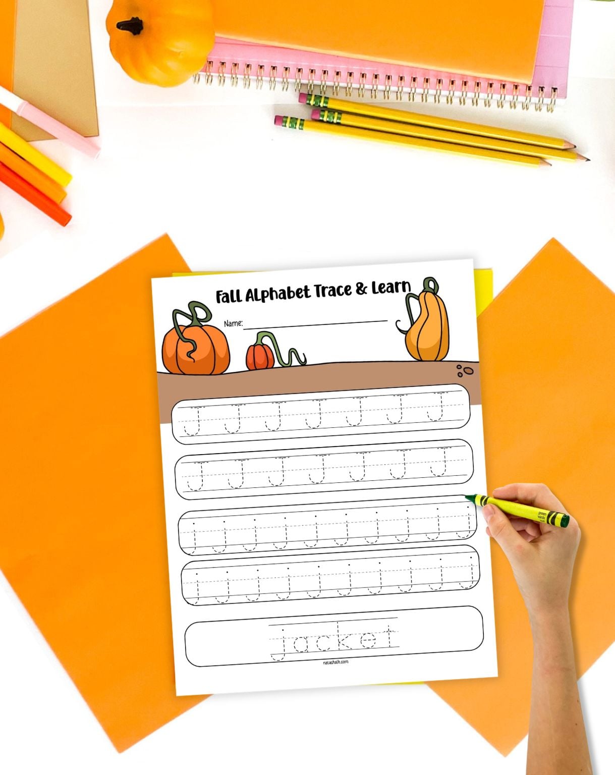 a hand preparing to trace a letter j worksheet